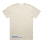 An off-white short-sleeve t-shirt with blue text at the bottom left reading 'CALVIN HARRIS 16 HAMPDEN PARK 2026', displayed flat against a white background.
