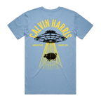 A light blue short-sleeve t-shirt with a graphic print on the back. The graphic features a black UFO casting yellow beams down, with a black pig silhouette under the beams.