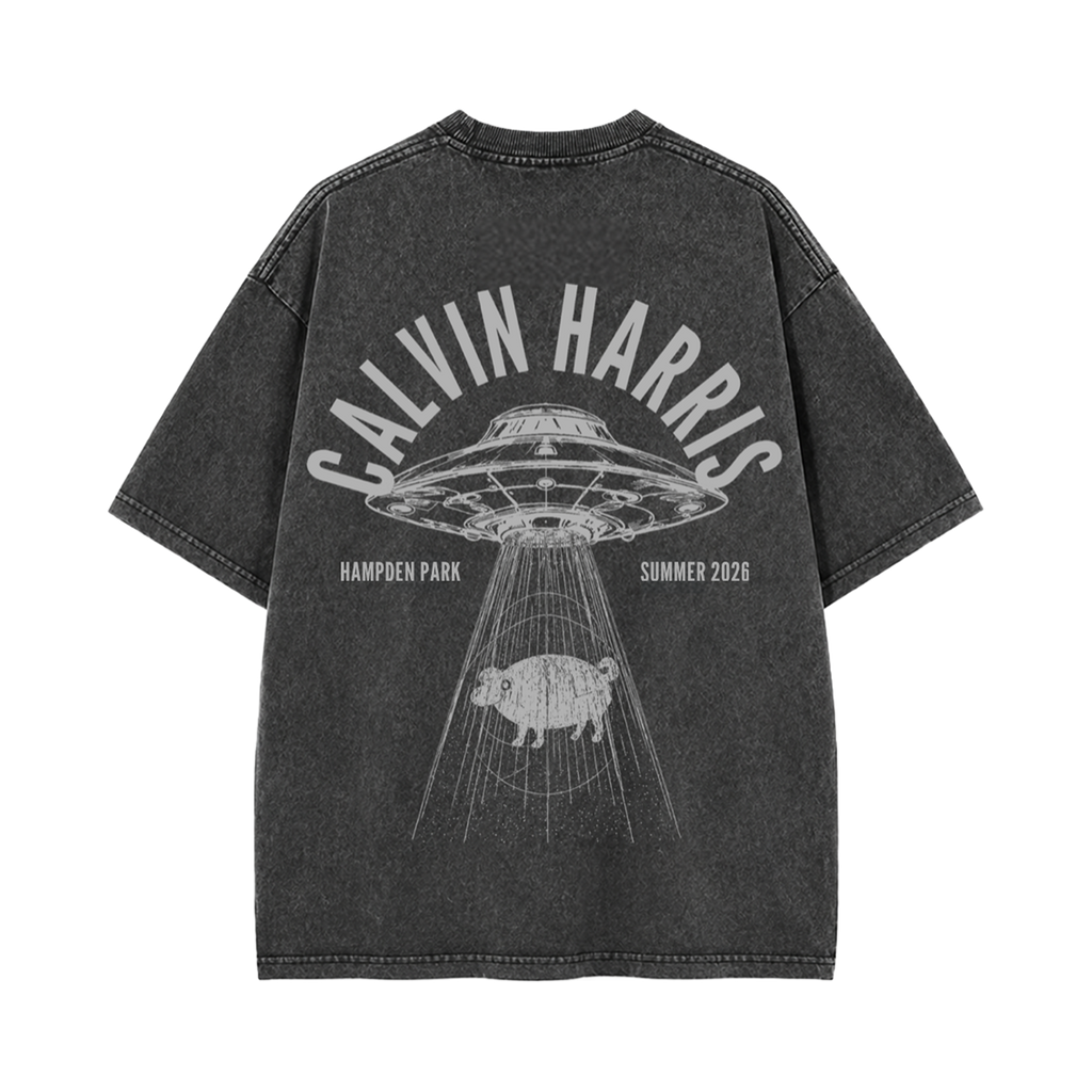 A dark gray mineral-wash t-shirt shown from the back, featuring a large white graphic print of a UFO, a pig, and the text 'CALVIN HARRIS', 'HAMPEN PARK', and 'SUMMER 2026'.